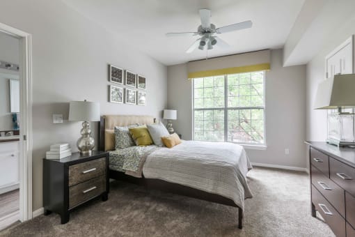a bedroom with a bed and a ceiling fan