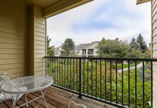 a patio with a table and chairs on a balcony