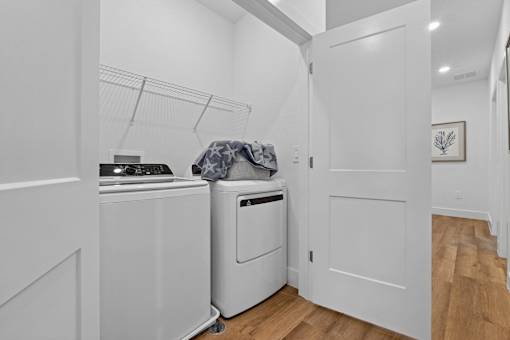A white laundry room with a washer and dryer.