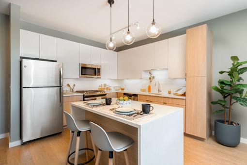 A modern kitchen with a dining table and chairs.