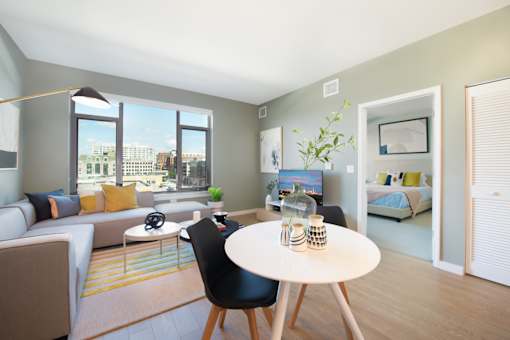 A modern living room with a large window and a view of the city.
