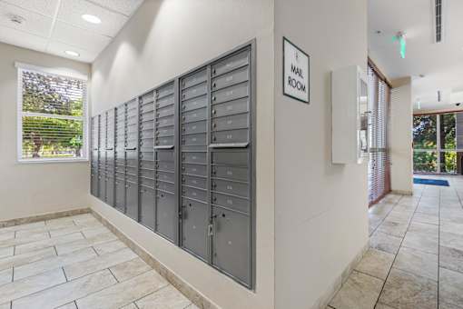 A row of mailboxes are lined up on a wall.