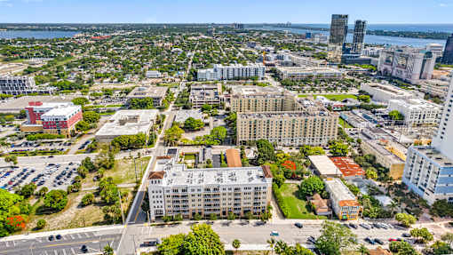A cityscape with buildings, roads, and greenery.