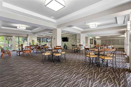 Community club house with tables, chairs, and bar seating