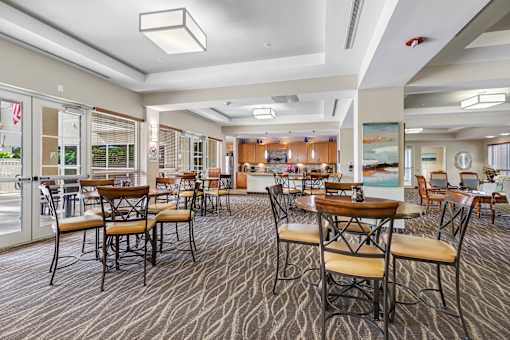 Community club house with tables, chairs, and bar seating