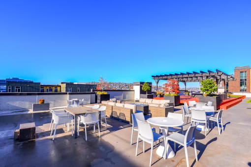 Luxury Apartments for Rent in Seattle - Union Bay - Rooftop with Outdoor Furniture, View of The City, and Planted Trees