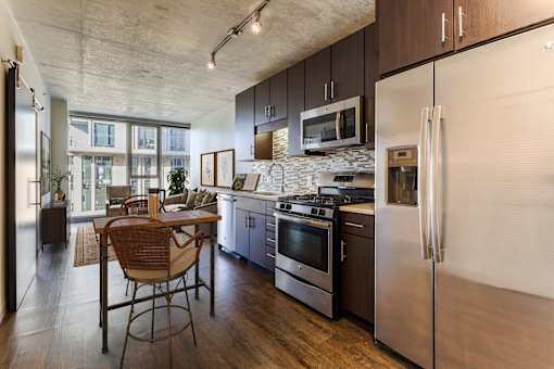A kitchen with a refrigerator, stove, and oven.
