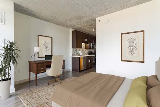 A room with a couch, desk, and chair.