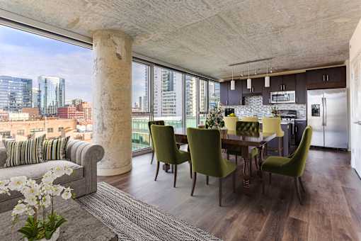 A modern kitchen with a dining table and chairs.