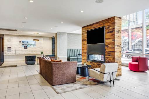 A reception area with a wooden pillar and a flat screen TV.
