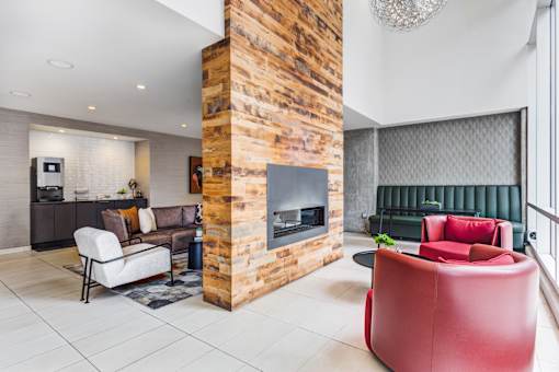 A modern living room with a fireplace and a green couch.