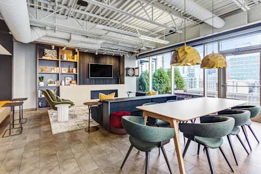 A modern dining area with a long table and chairs.