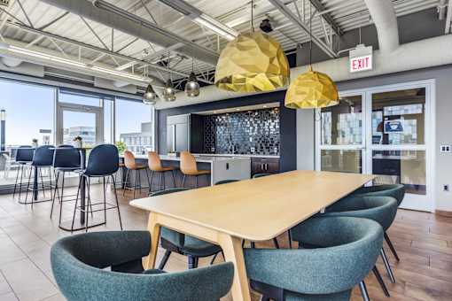 A conference room with a long table and chairs.