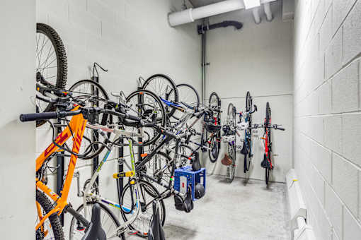 A bike rack full of bicycles in a white room.