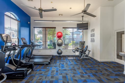 the gym at the district at highland village apartments