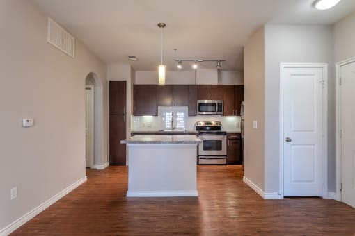 an empty kitchen with an island in the middle
