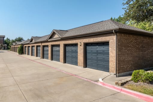 a row of garage doors on a brick building