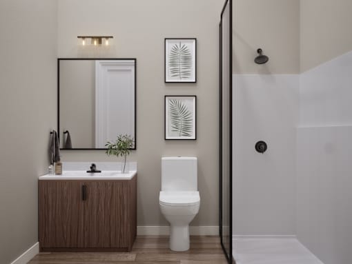 A bathroom with a toilet, sink, and mirror.