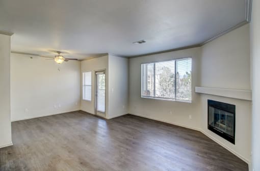 an empty living room with a fireplace