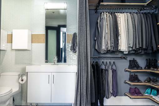 A bathroom with a white toilet and a white cabinet.
