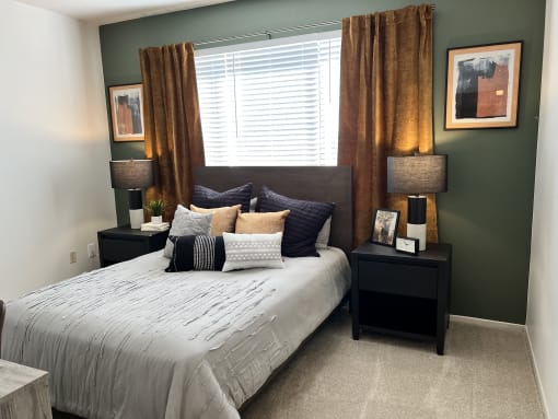 a bedroom with a large bed in front of a window