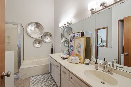 Townhomes In Woodbury - Large Bathroom With Hard-Wood Flooring, Dual Sinks, Large Mirrors, And Separate Tub And Shower.