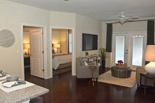 A living room with a grey couch and a television.