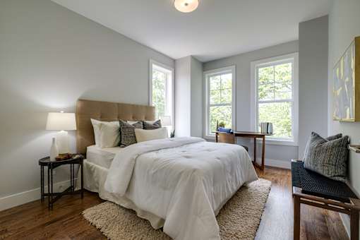 A bedroom with a large bed and a window.