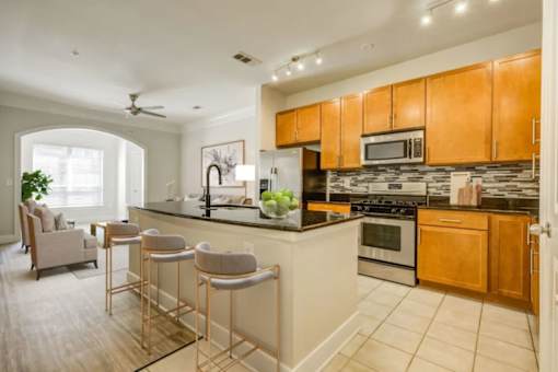 A kitchen with a bar area and a dining area.