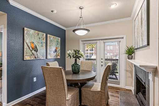 A dining room with a table and chairs.