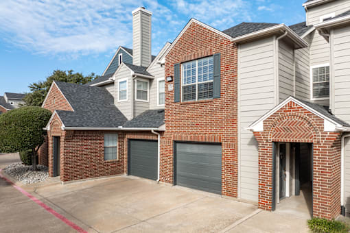 A house with a brick facade and a garage door.