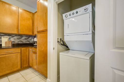 A white oven is built into a wall in a kitchen.