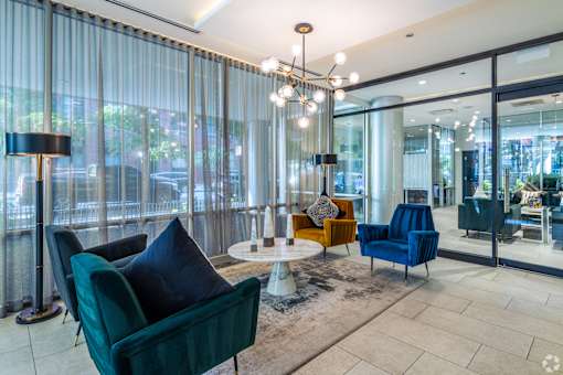 A living room with a green chair and a blue chair.