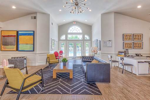 A large, well-lit room with a variety of furniture and artwork.