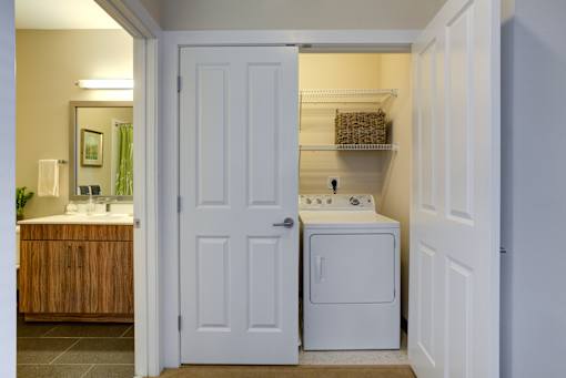 A white door is open to a laundry room.