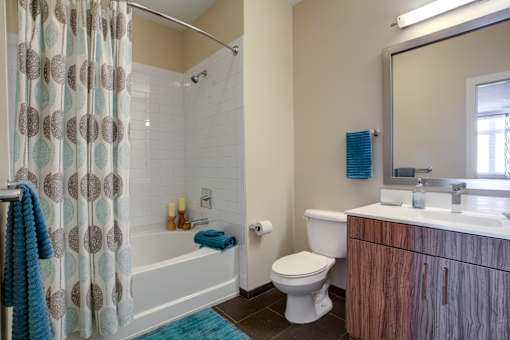A bathroom with a toilet, sink, and shower.