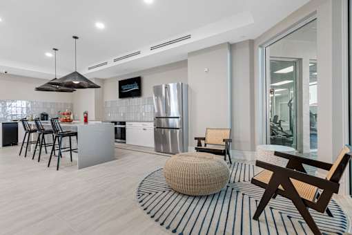 A modern kitchen with a dining table and chairs.