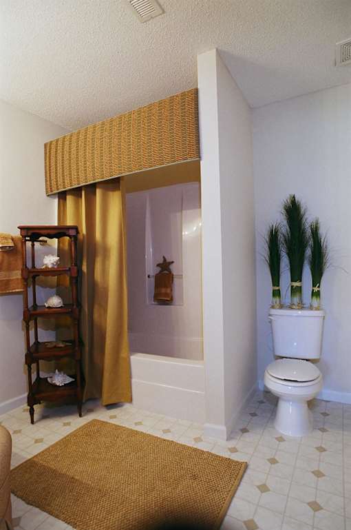 A bathroom with a toilet, a sink, and a shower.