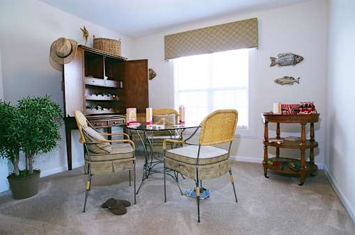 A dining room with a table and chairs.