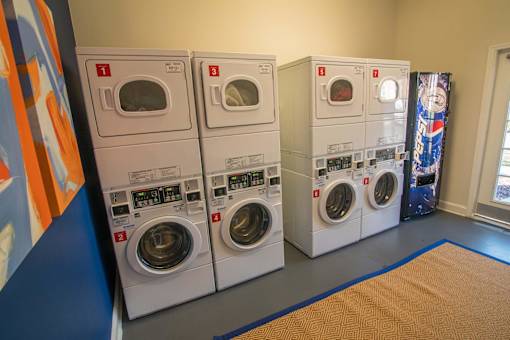 Three washing machines are lined up in a row.