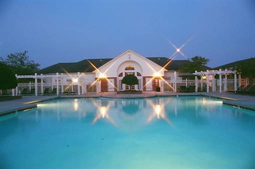 A large house with a pool in front of it.