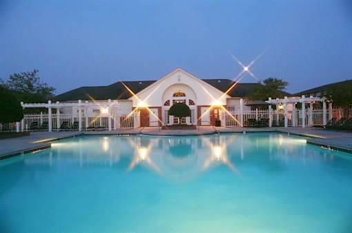 A large house with a pool in front of it.
