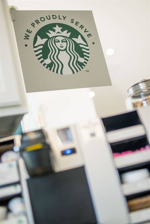A Starbucks sign hangs above a counter.