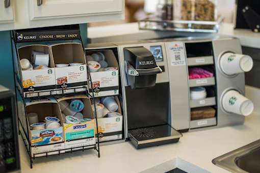A Keurig coffee maker is on a kitchen counter.