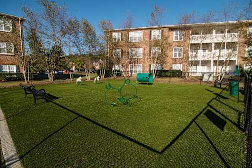 A green net is set up in the middle of a grassy area.