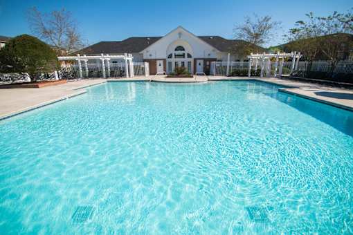 A large swimming pool in front of a building.