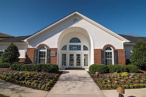 A white building with a brick border and a sign that says 500.