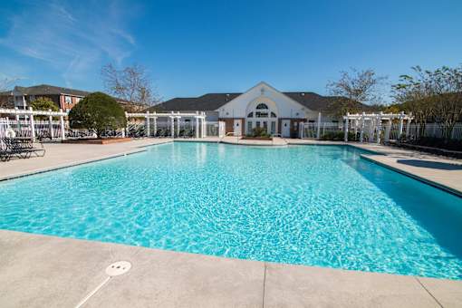 A large swimming pool in front of a building.