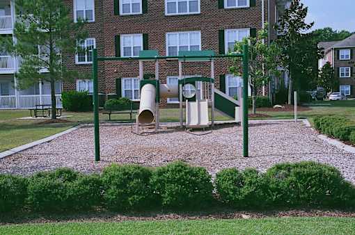 A playground with a slide and a tunnel.
