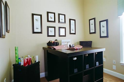 A black desk with drawers and a mirror above it.